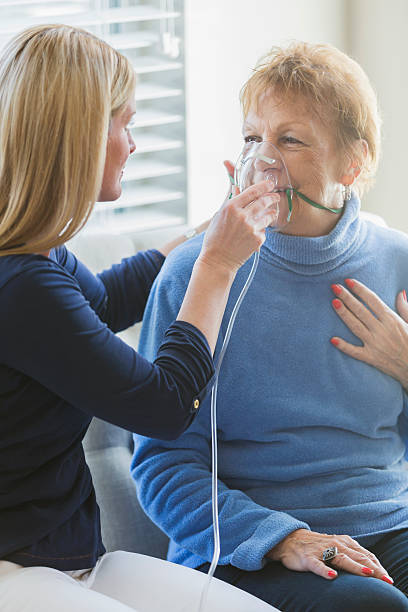 nurse is helping put an oxygen mask