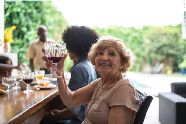 senior woman drinking grape juice