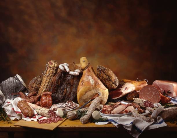 A still life with an assortment of Italian hams, salamis and sausages